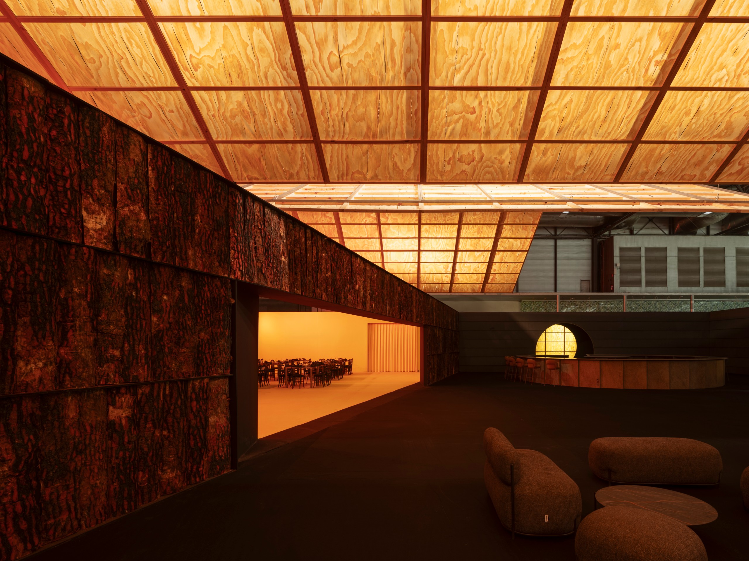 Walls clad in charred timber slabs beneath glowing planes