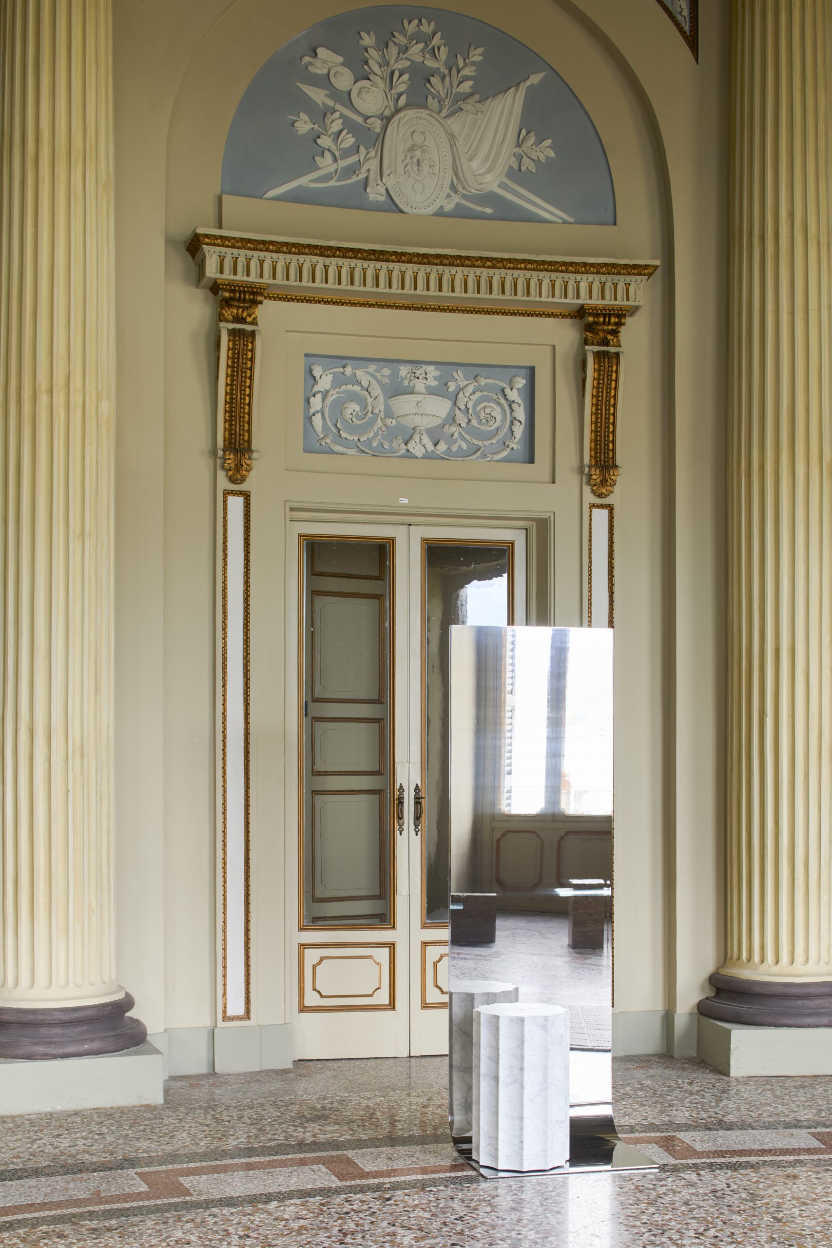 The reflective mirror of Meditations placed in a doorway at Villa Saporiti