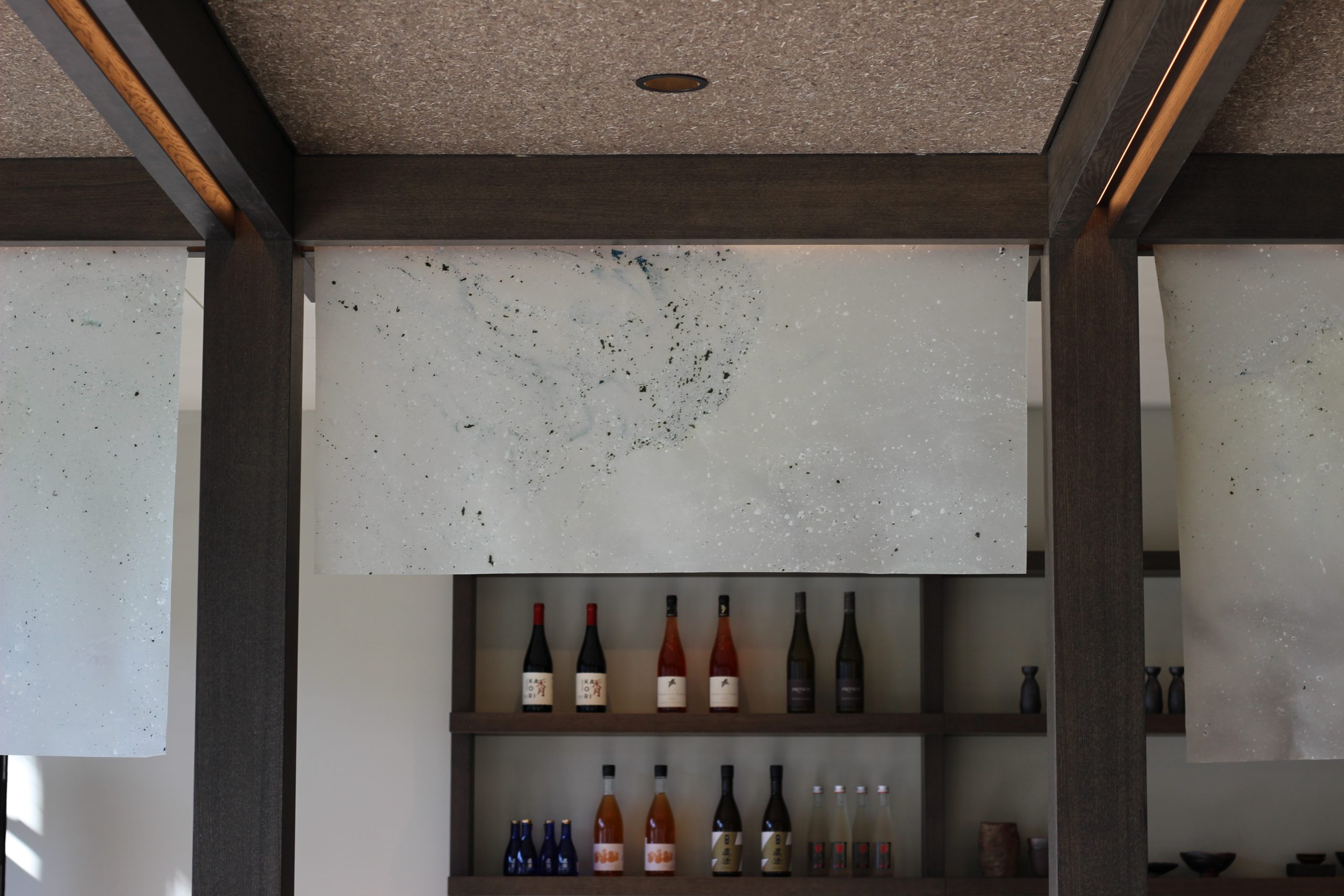 Layered bio-textile forms diffuse light in the restaurant interior