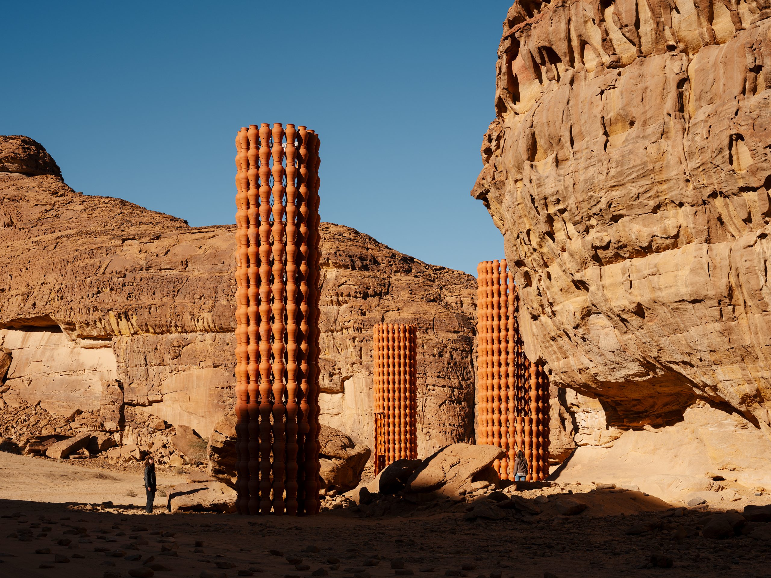 The tower’s cut-out pattern creates a changing screen between the viewer and the landscape.