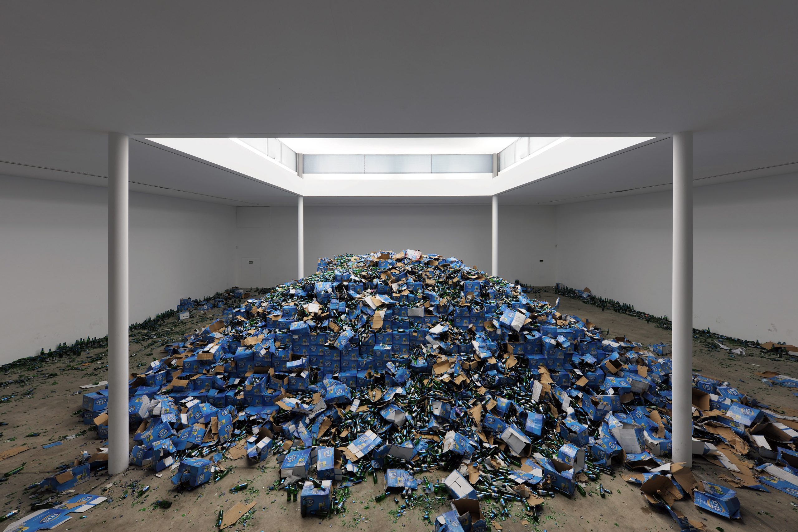 Bottles and cardboard cases scattered across the gallery floor