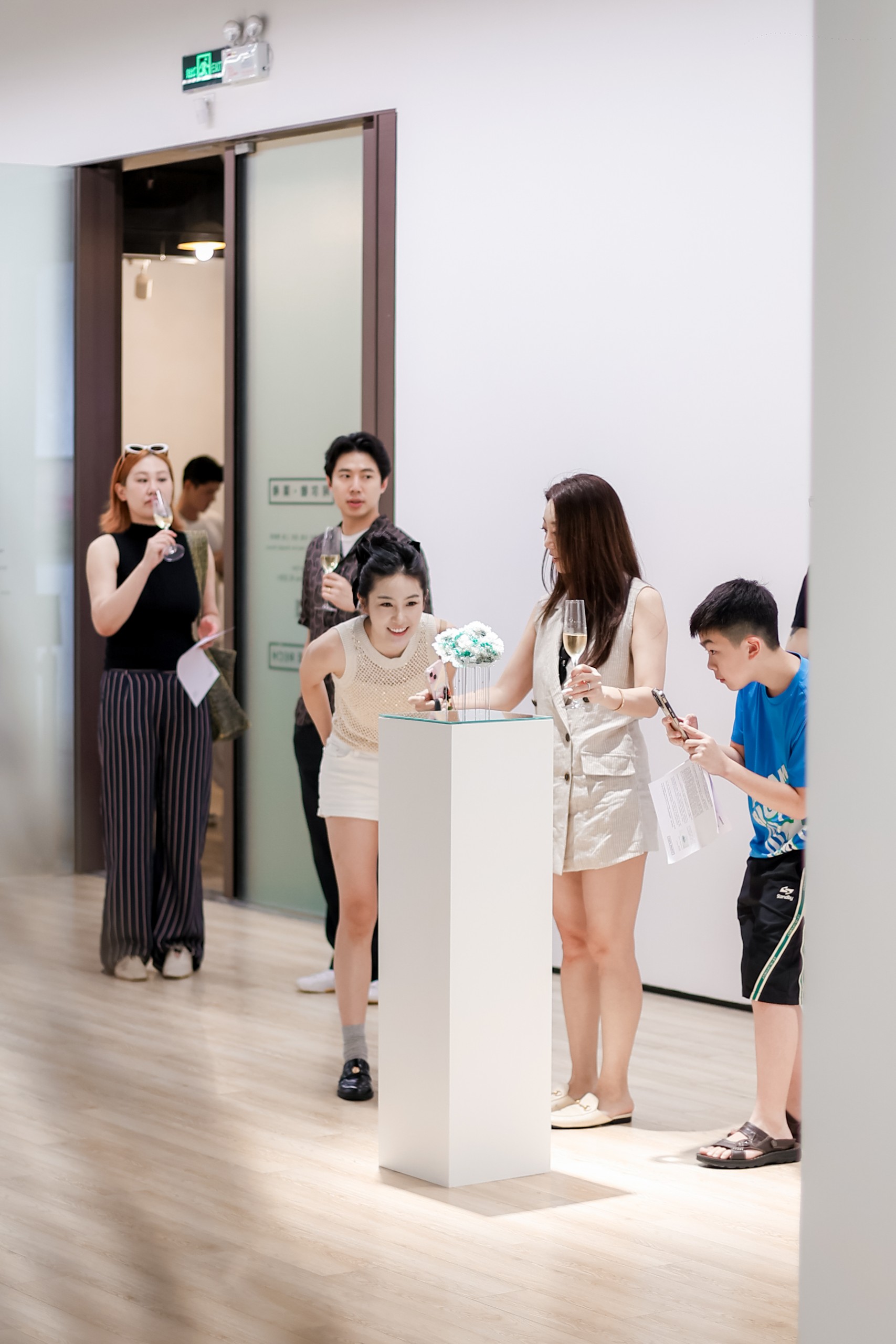 Visitors around a plinth near the gallery entrance