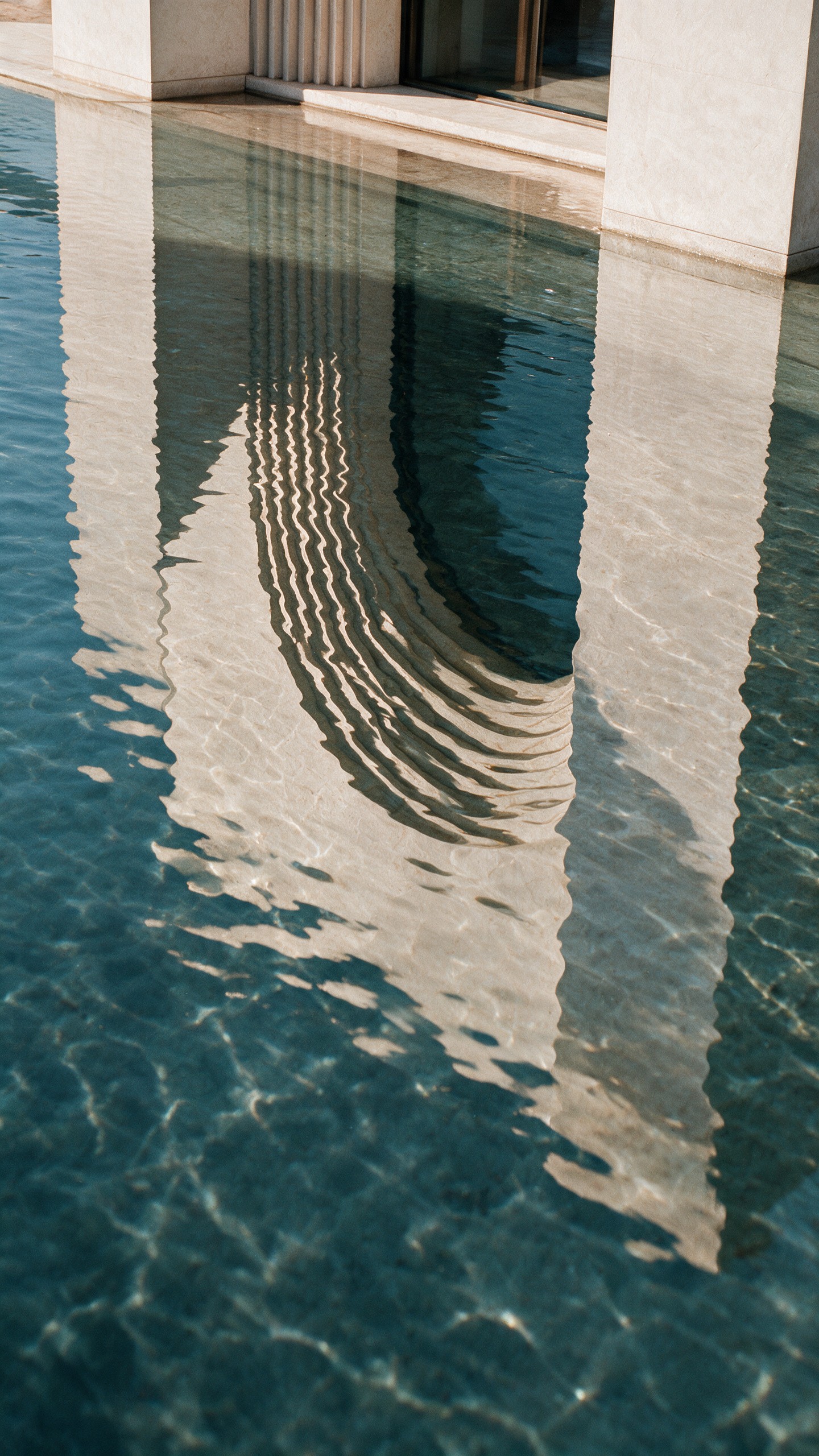 Museum of Contemporary Art Riyadh by Balzar Architects, the rings of the arch reflected in the pool