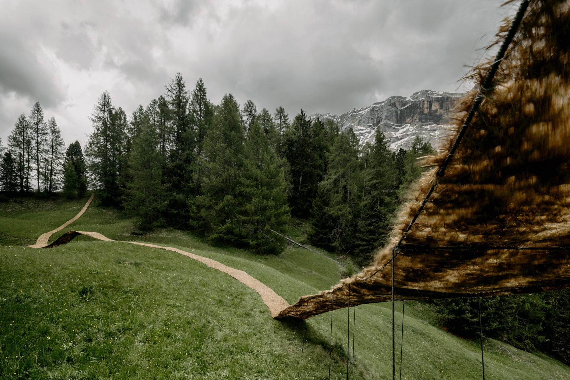 Trace of Land by ELSE, a meandering hay canopy across the Armentara meadows in Val Badia