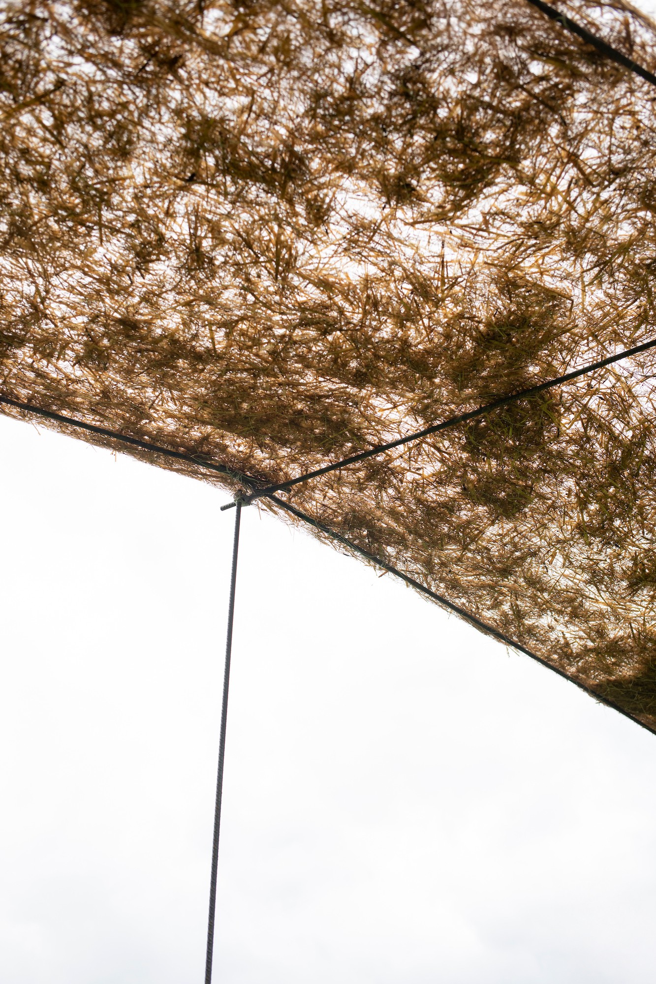Trace of Land by ELSE, a meandering hay canopy across the Armentara meadows in Val Badia