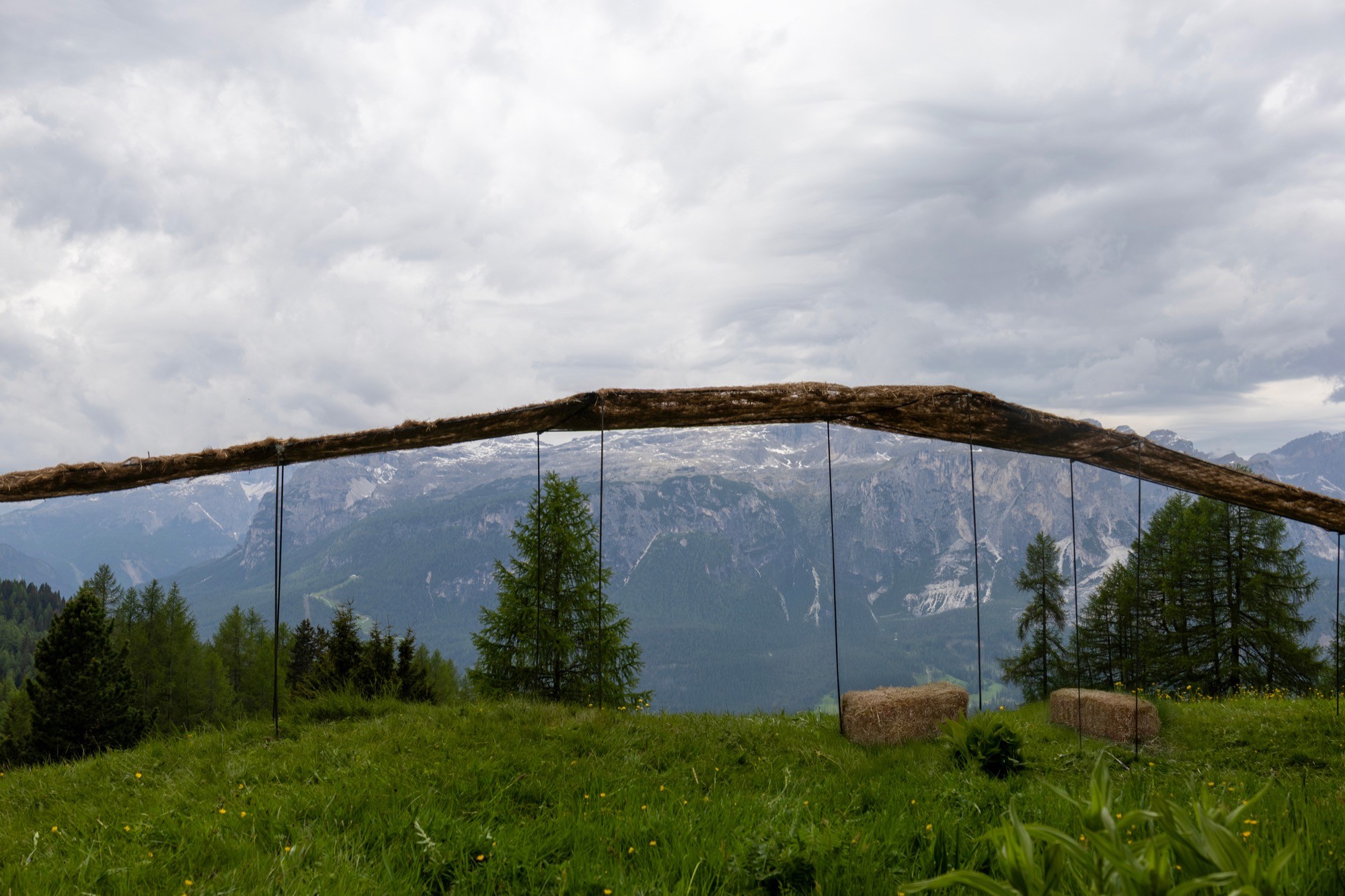 Trace of Land by ELSE, a meandering hay canopy across the Armentara meadows in Val Badia
