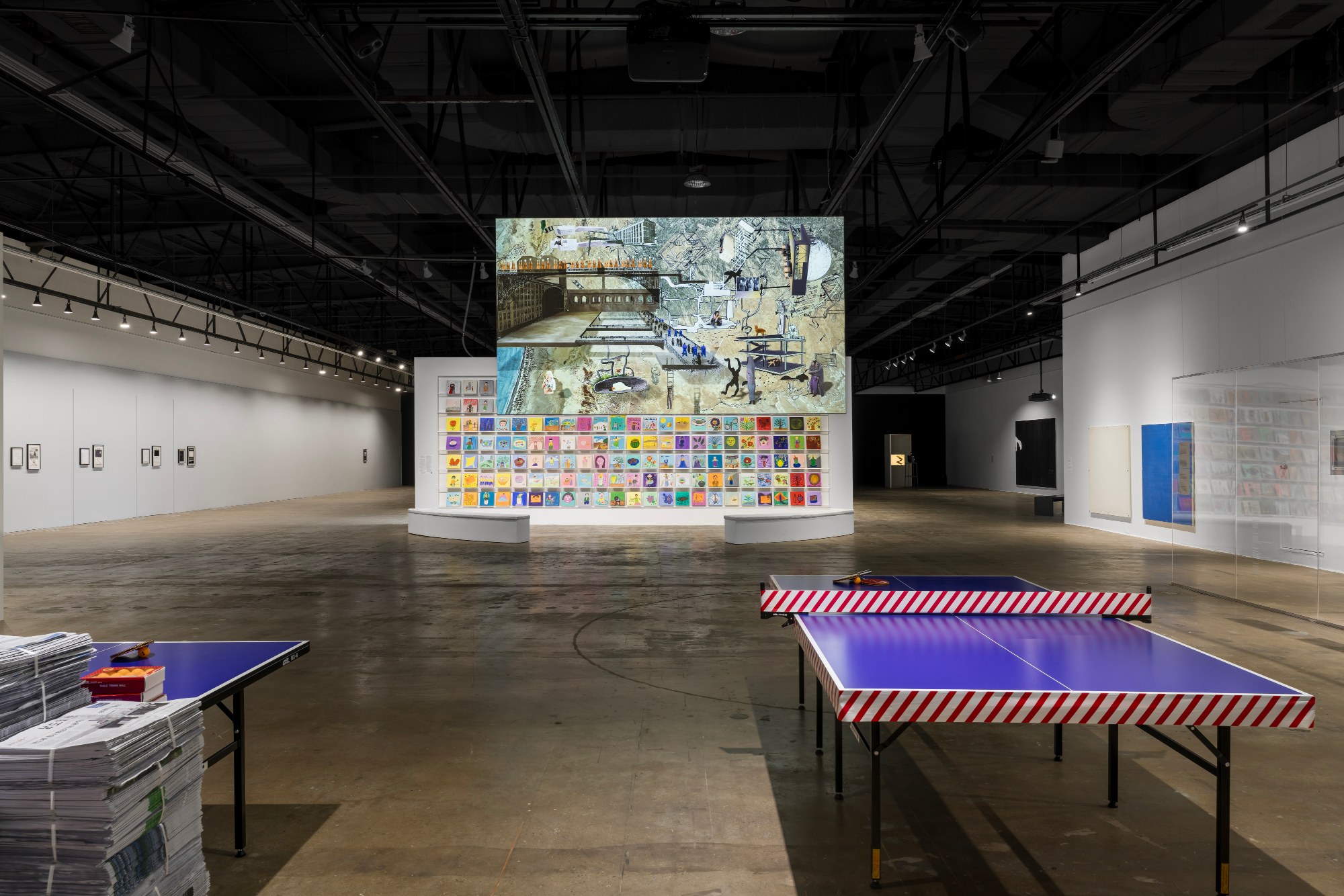 Gallery 2 with table-tennis tables and a wall of images