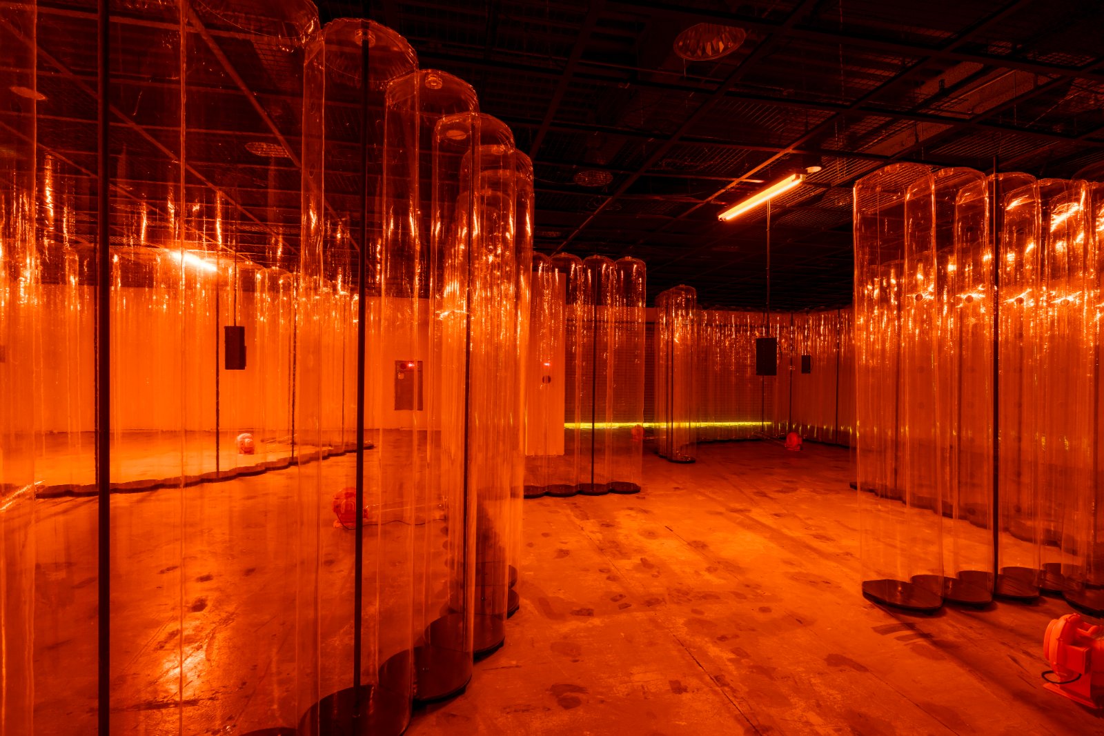 Transparent vinyl inflatables lit in orange in Gallery 5