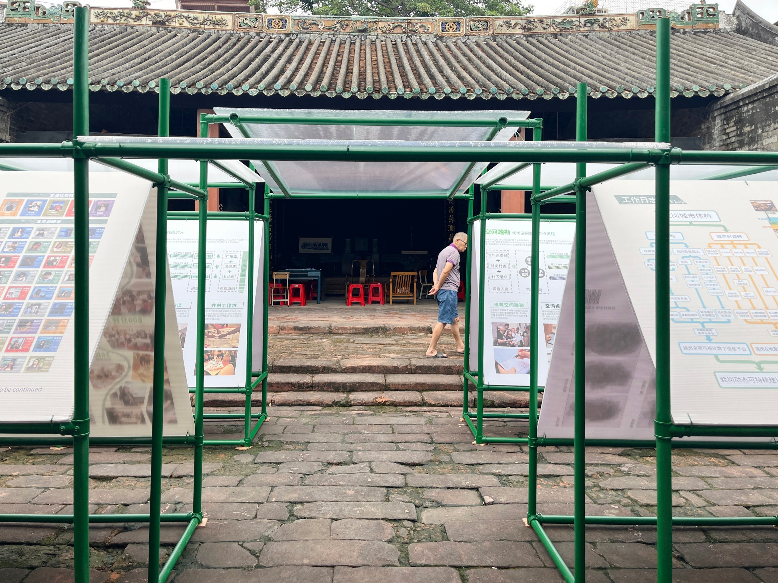 Villagers pass through the exhibition on their way into the hall