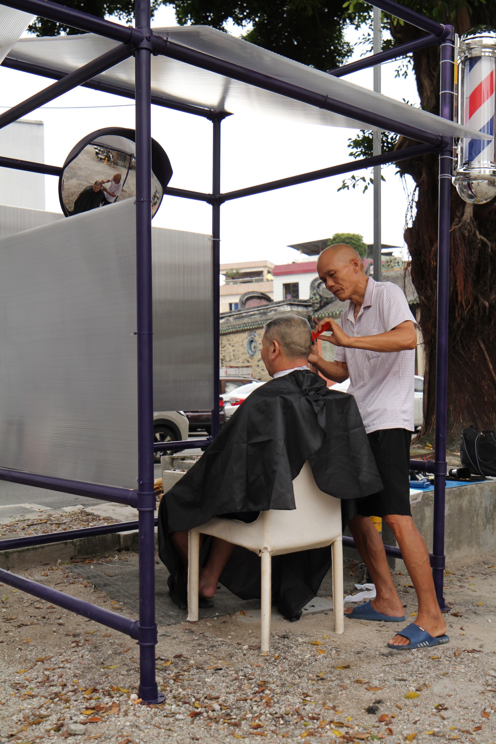 A haircut in progress at the pavilion