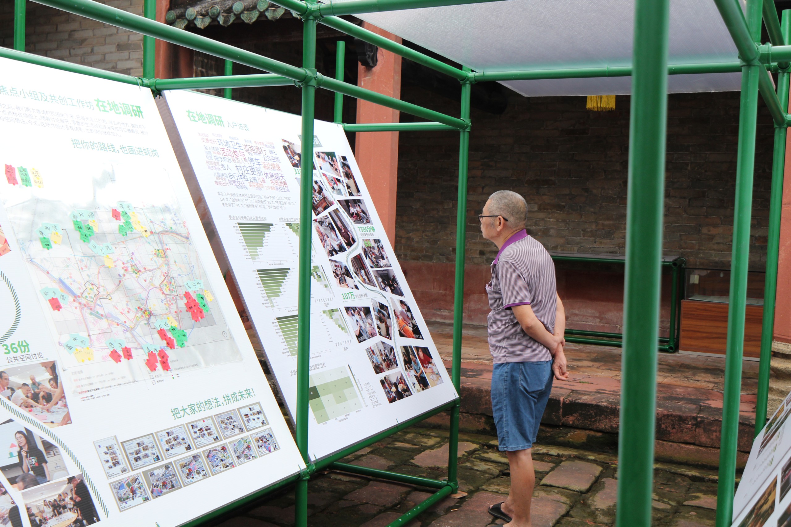 Villagers stop to read the panels