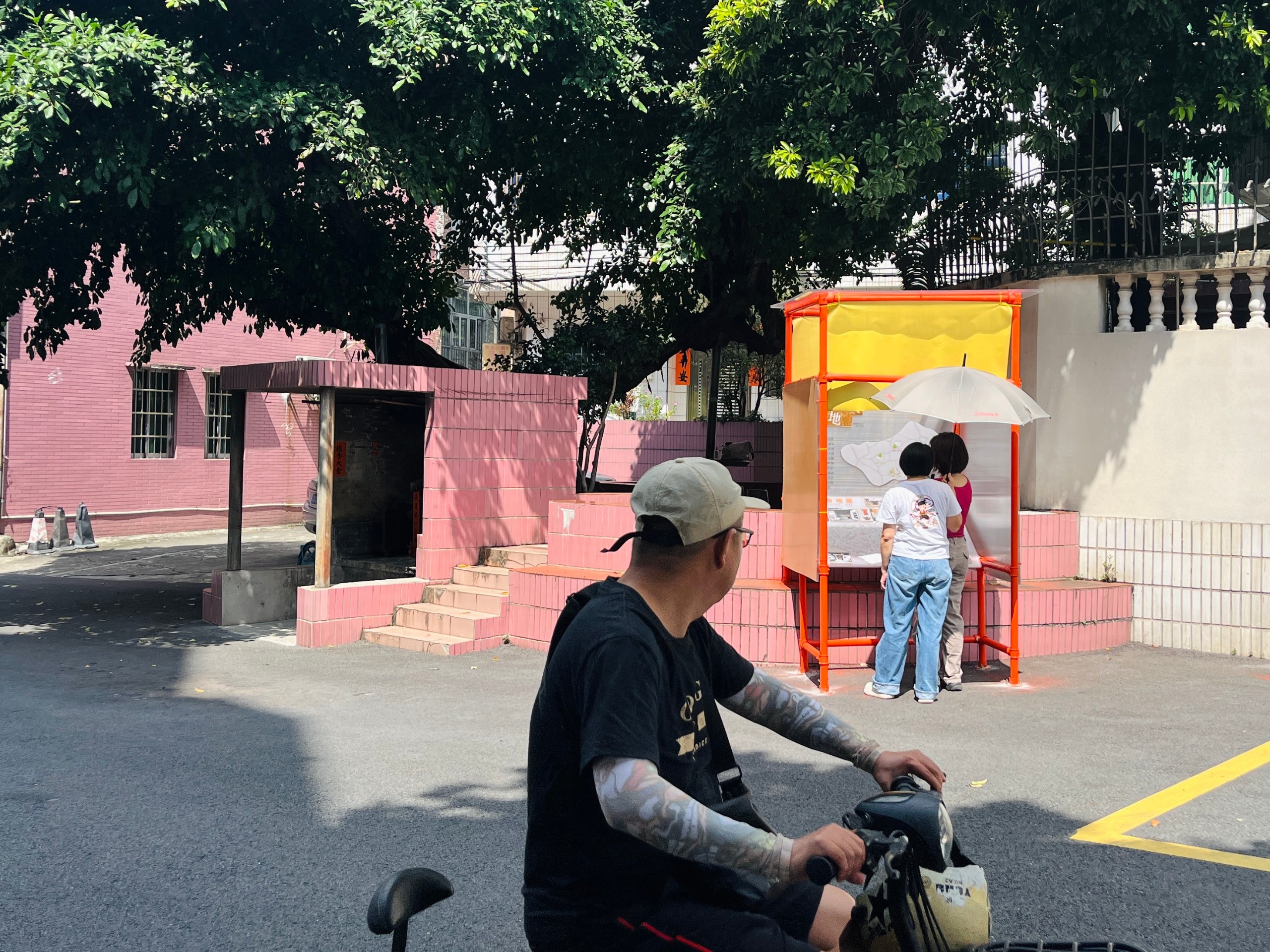 Residents pause at the exhibition on the street
