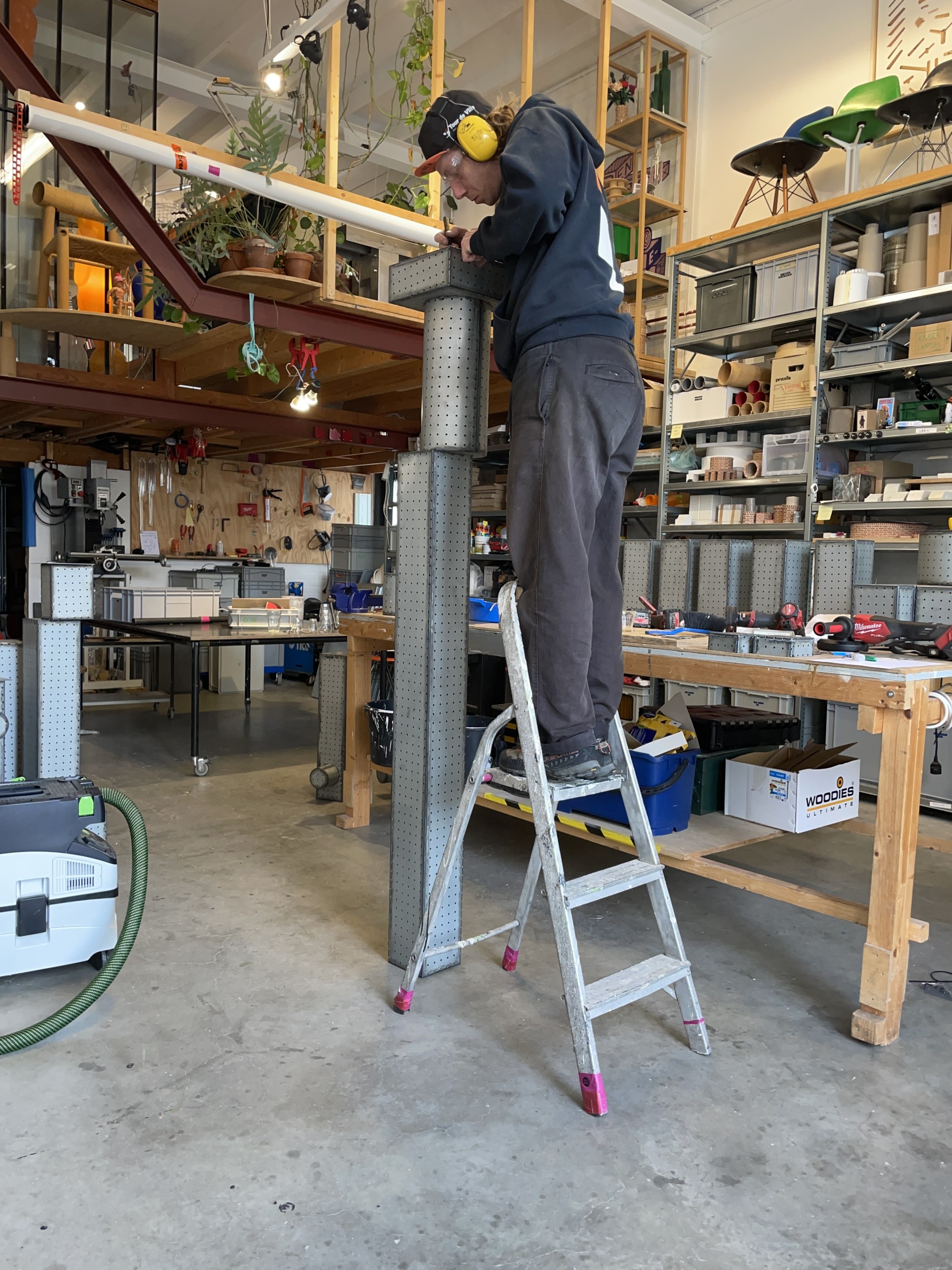 Assembling a tall pegboard lamp in the workshop
