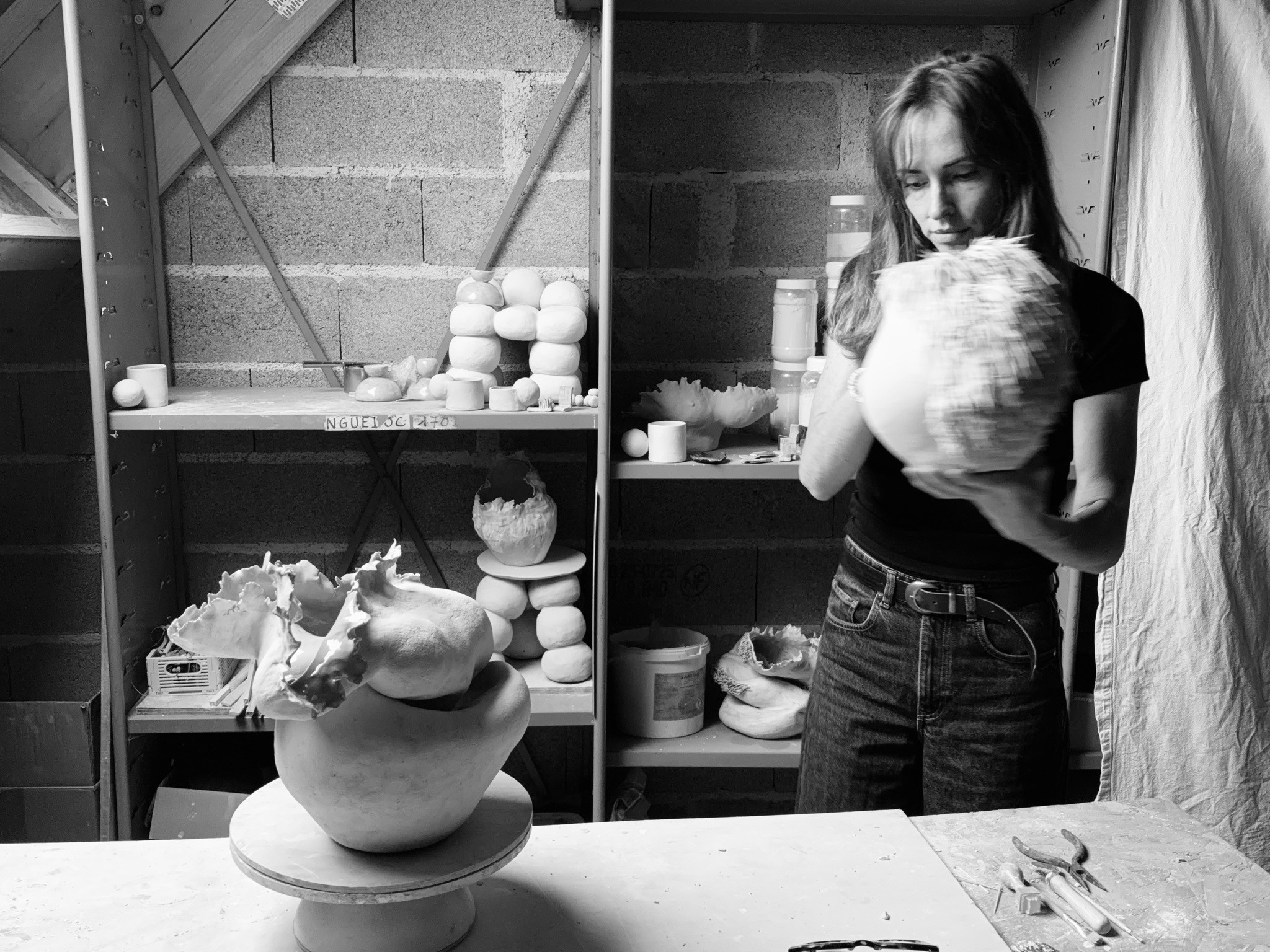 Manon Benoit with her work in her ceramics studio.