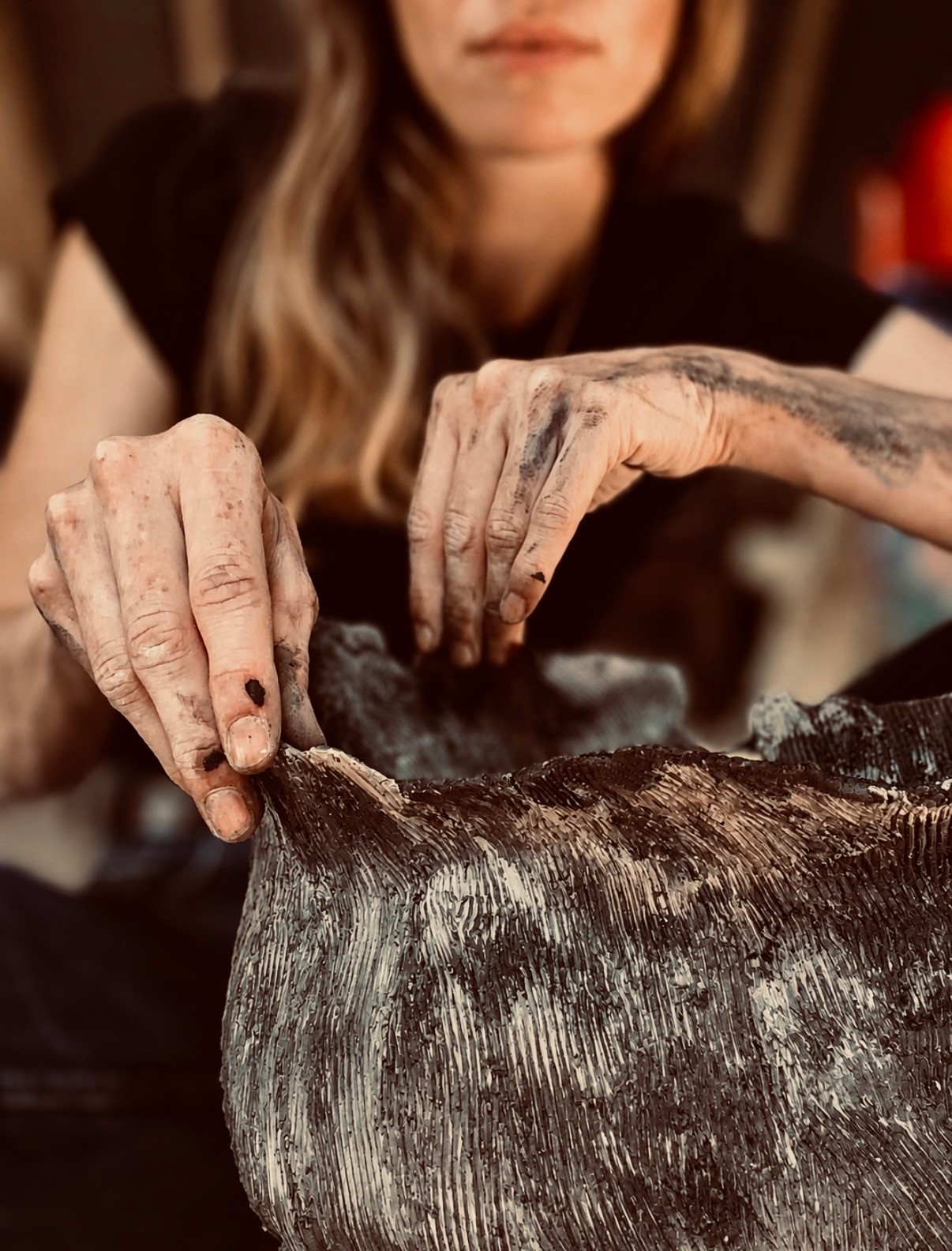 Manon Benoit creating a ceramic work.