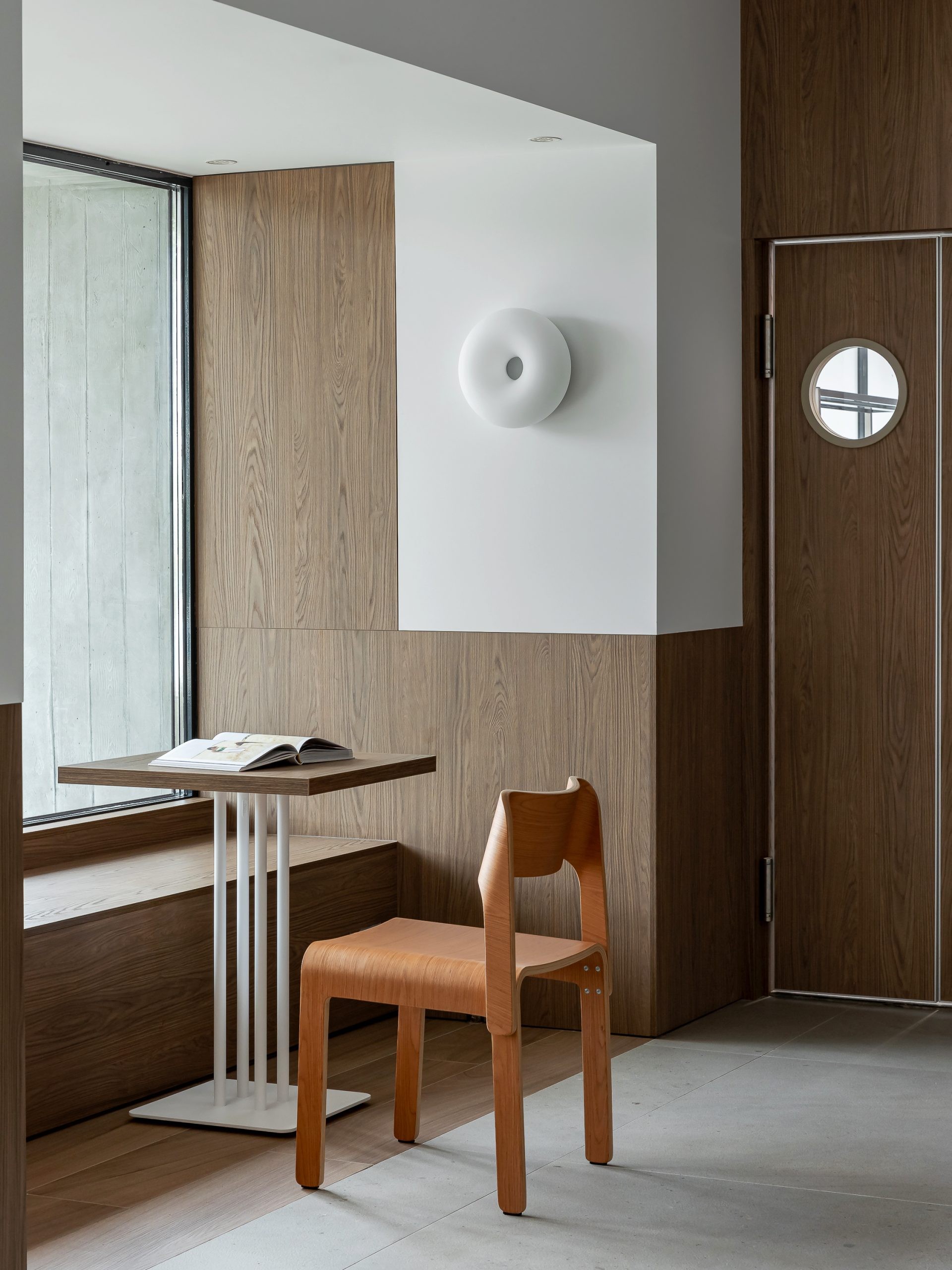 Shelving and loose furniture create different scales of occupation without enclosing the plan.