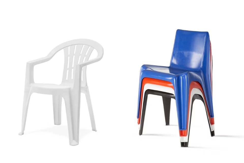 White monobloc chair beside stacked Bofinger chairs