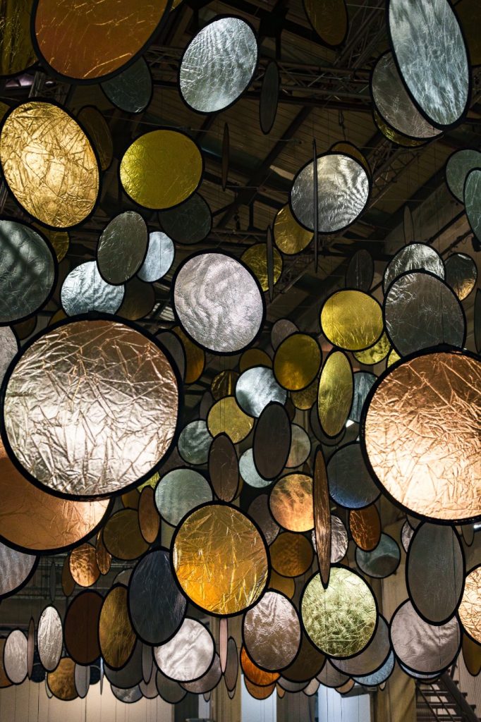SpY, HALOS, gold and silver reflective circles suspended in a former railway factory in Florence