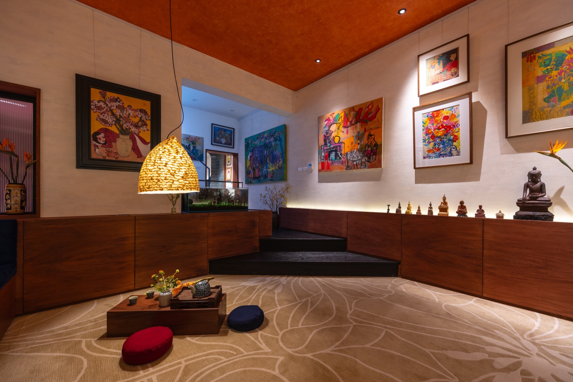 The Nest by Comma.Studio: the sunken living room below the painting wall