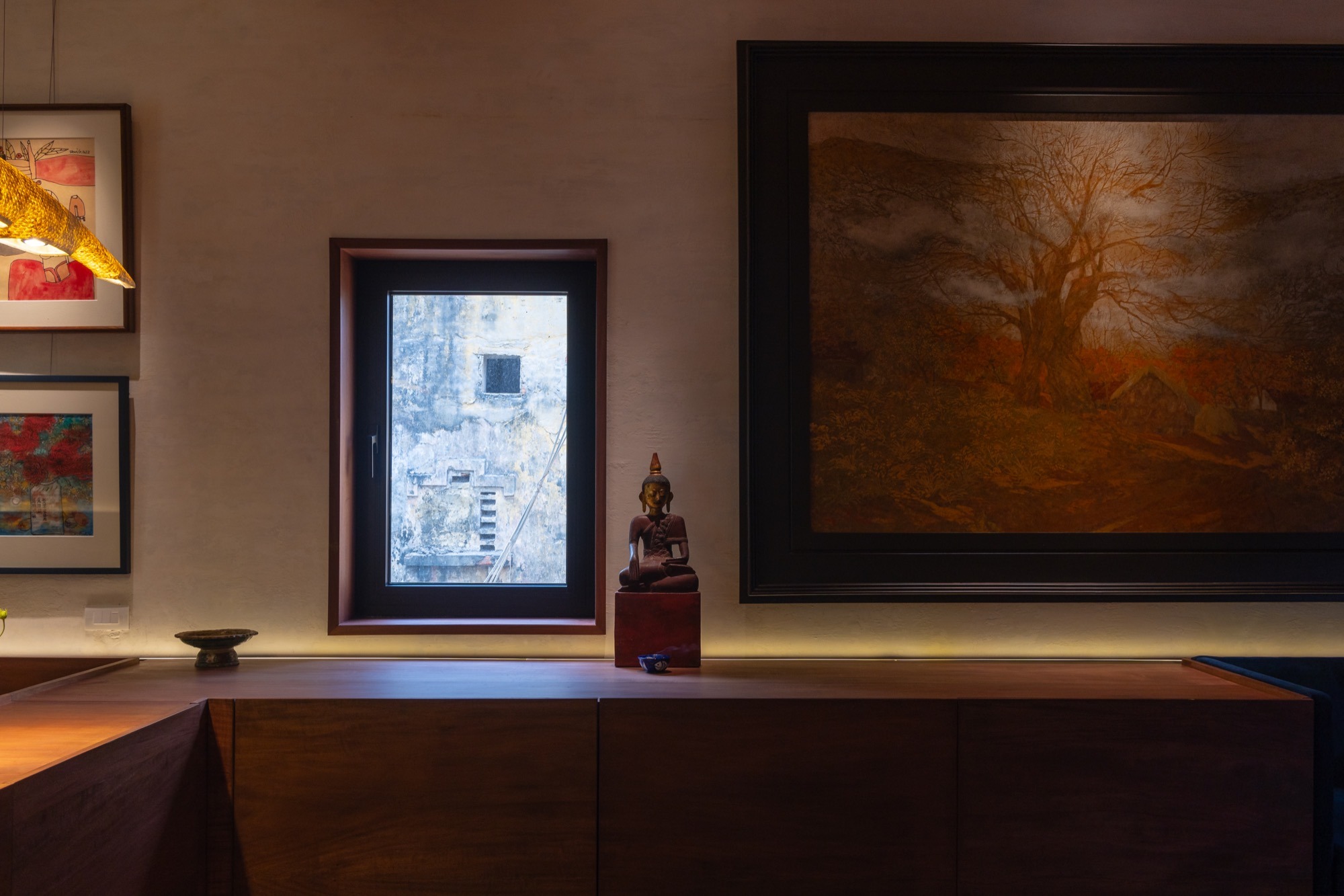 Built-in timber joinery and a painting at the end of the room