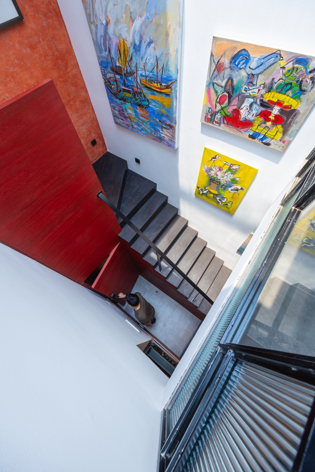 The Nest by Comma.Studio: looking down the lightwell beside the stair