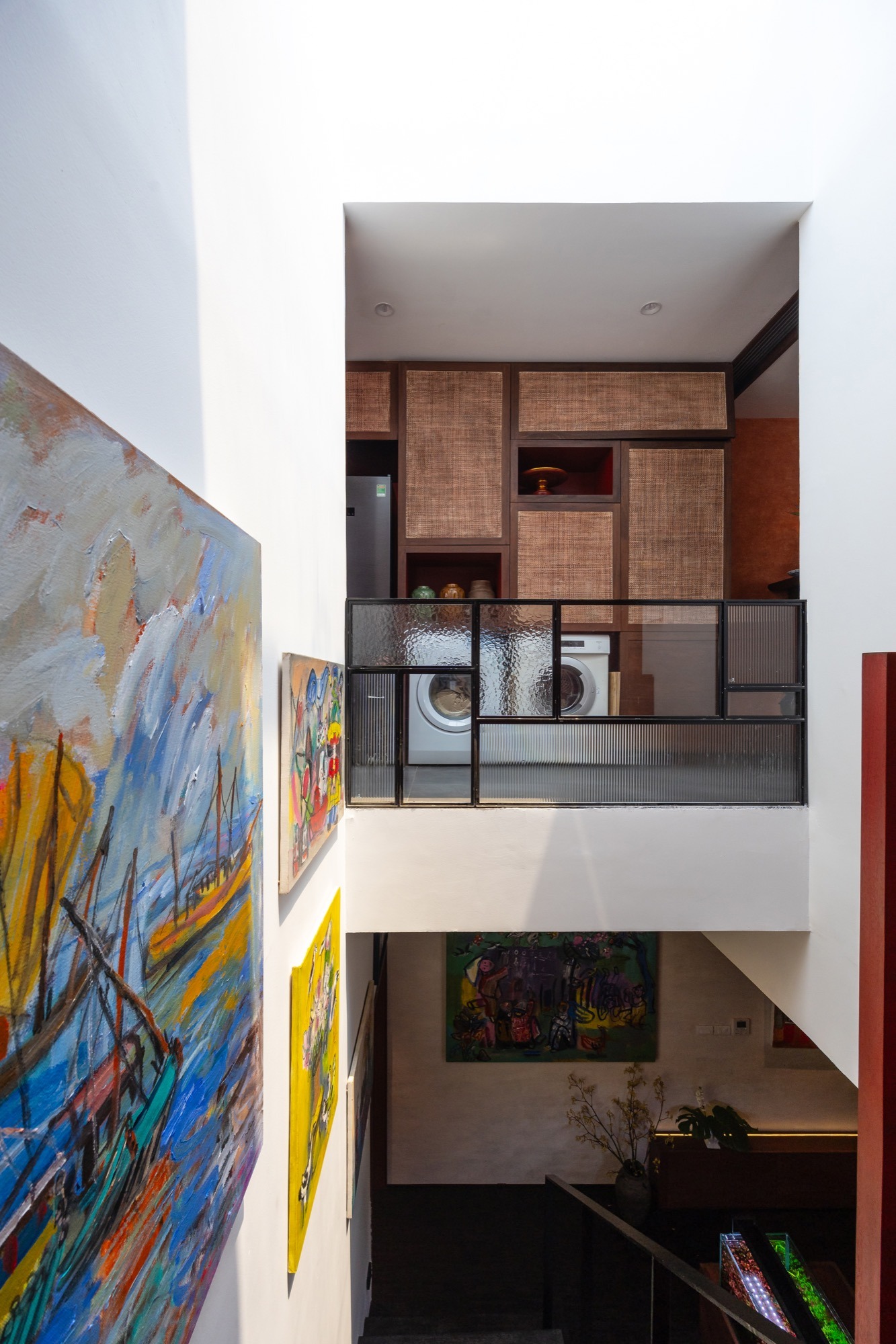 Paintings along the lightwell, seen from the stair