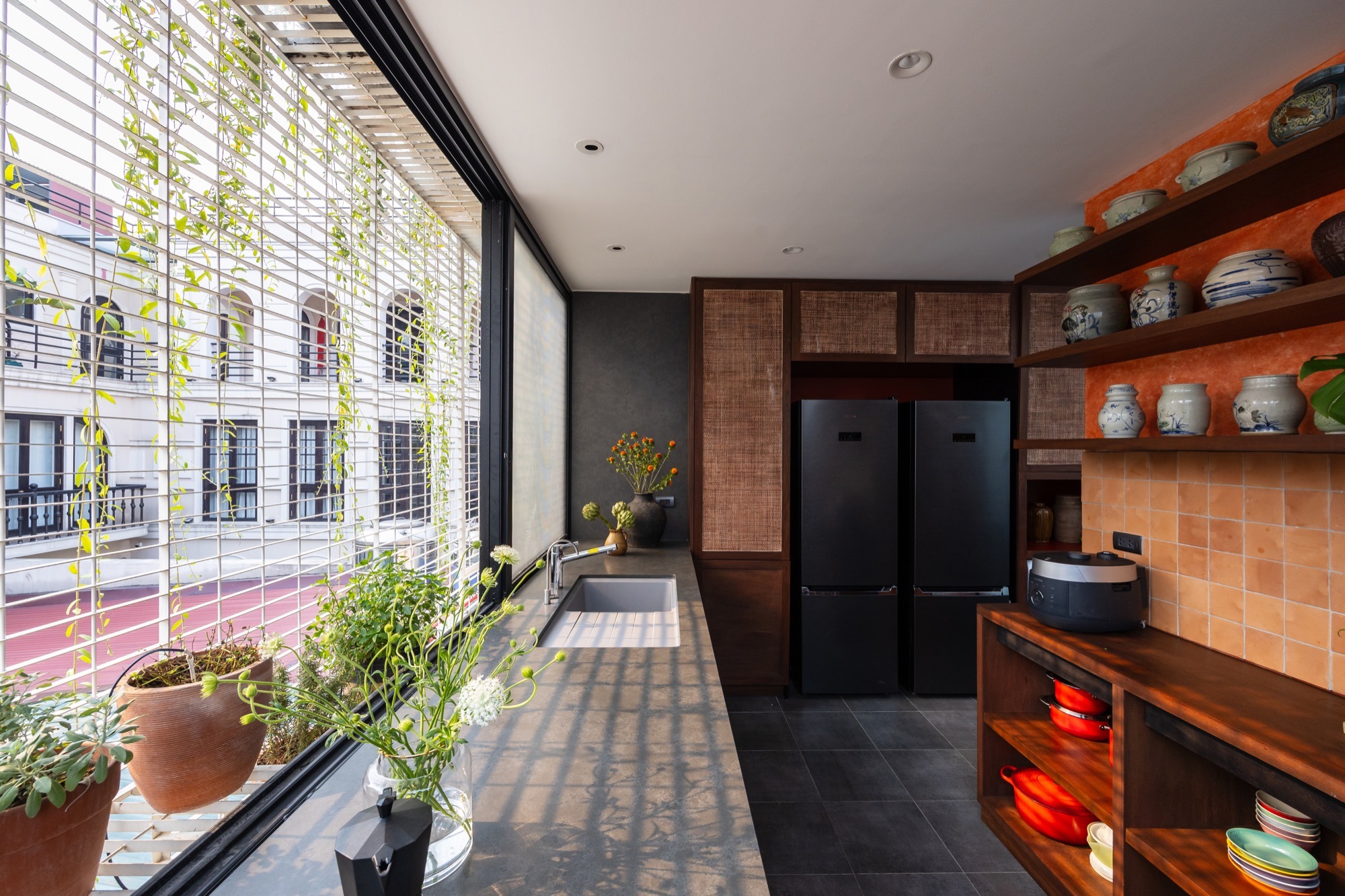 The Nest by Comma.Studio: the kitchen, with open shelves and a window onto the street
