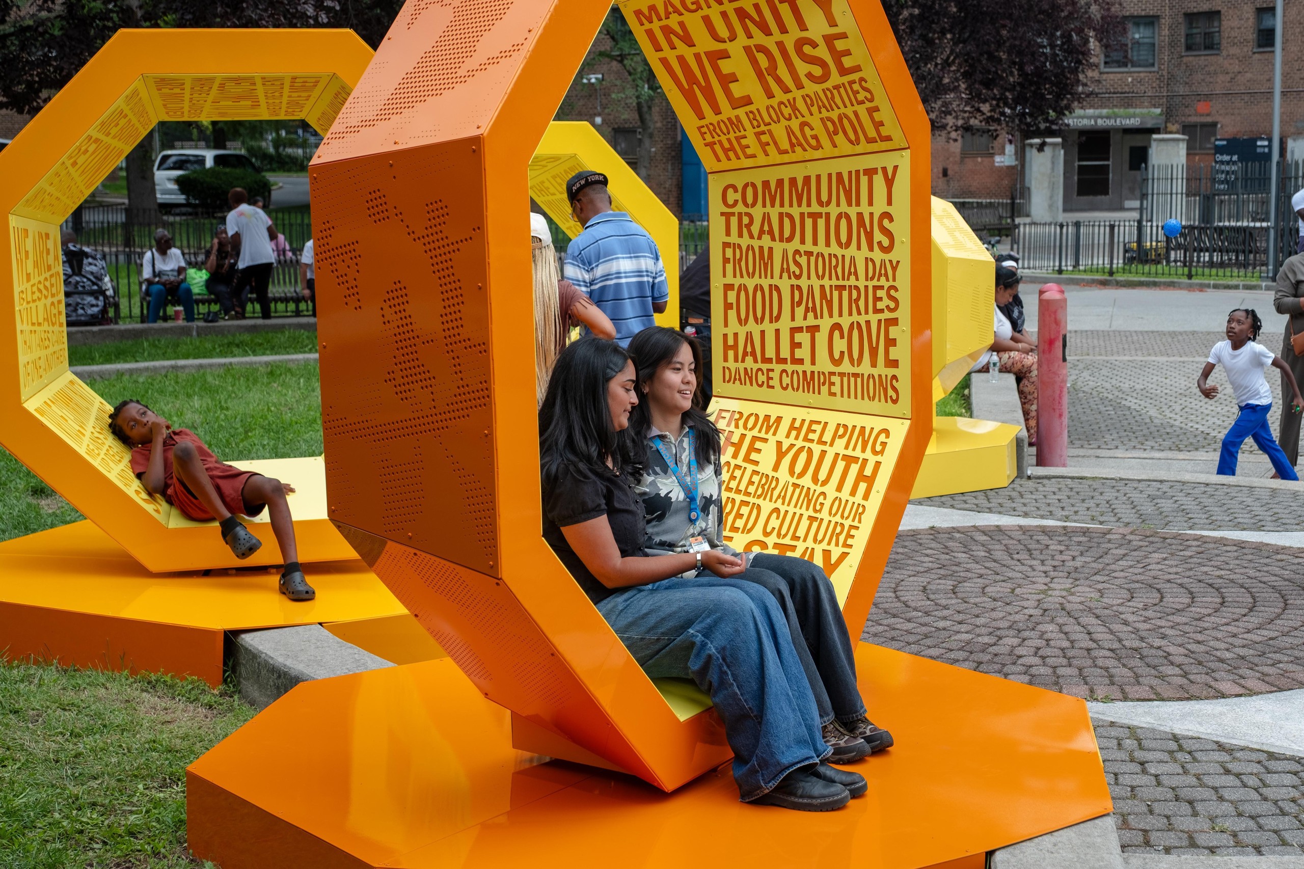 Residents sitting inside an orange octagonal structure