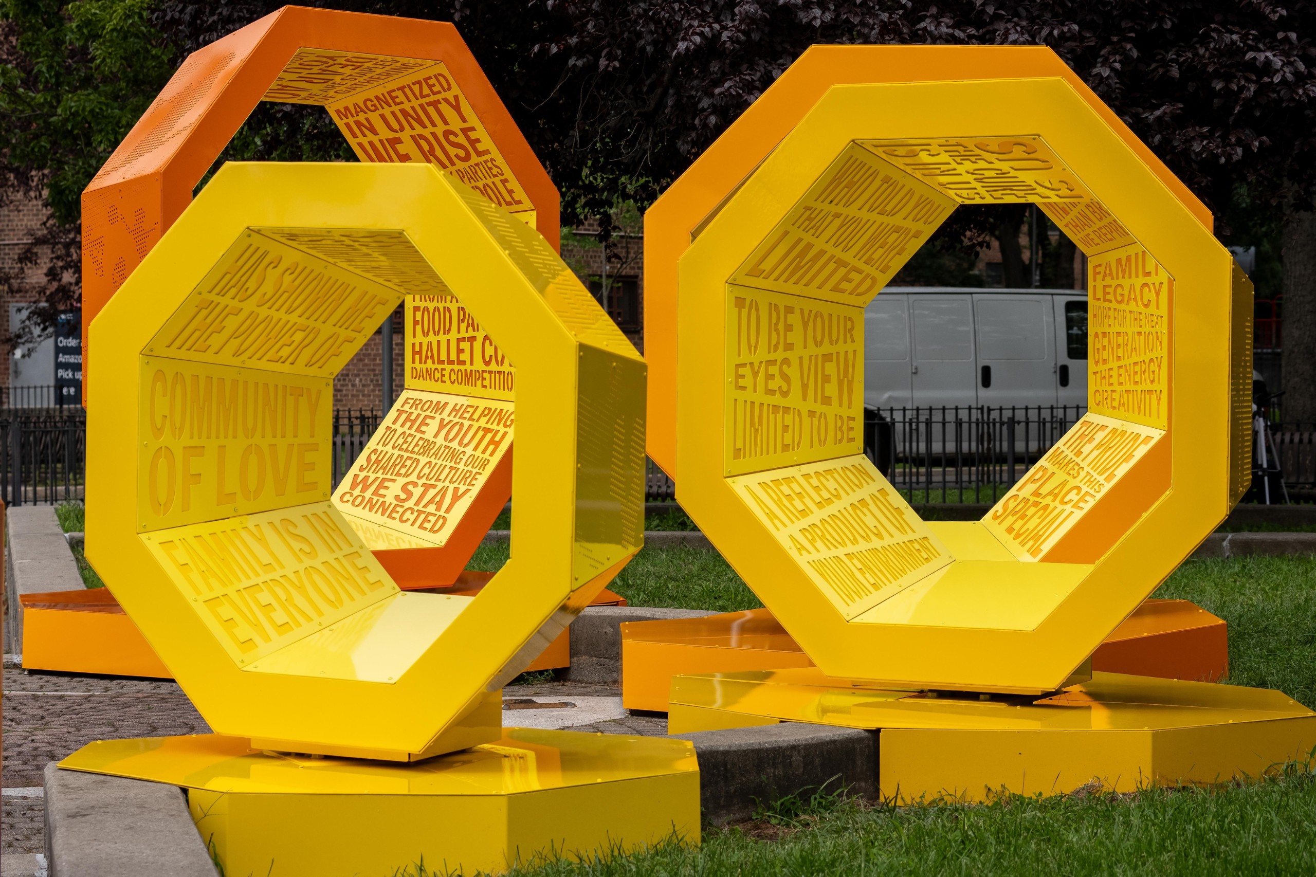 Yellow octagonal structures wrapped in cut-out text