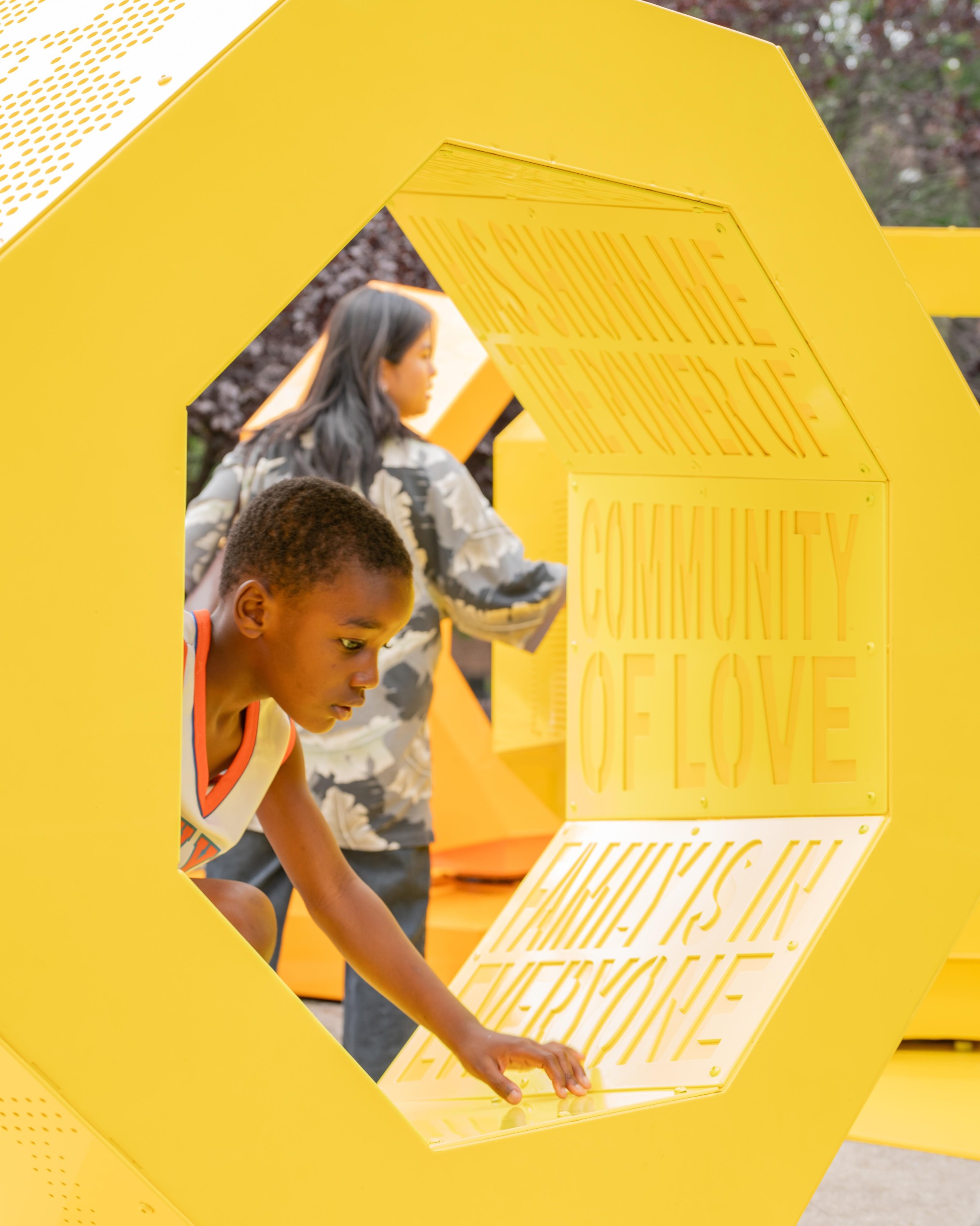 Child touching cut-out words inside a yellow form