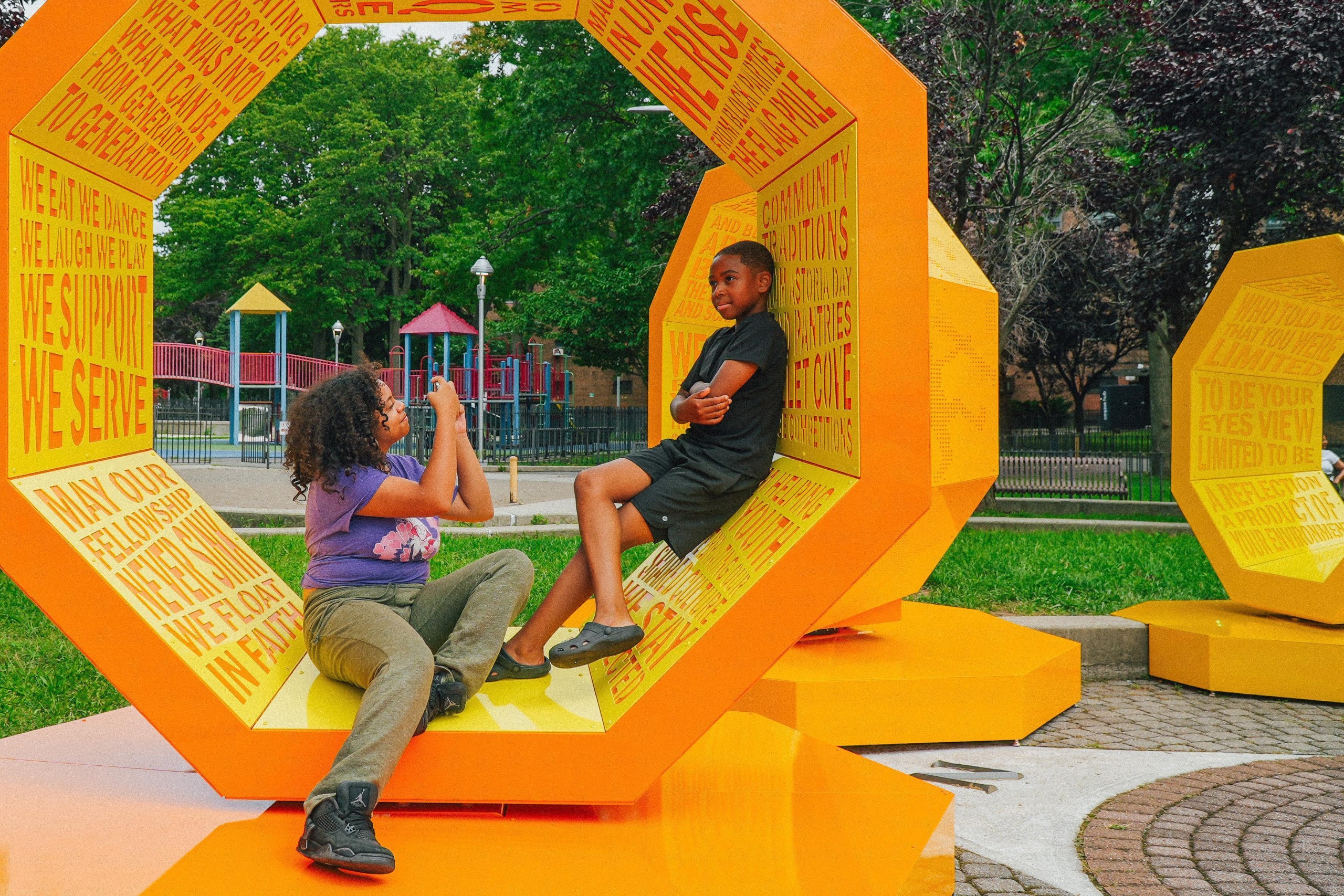 Two people sitting inside an orange form